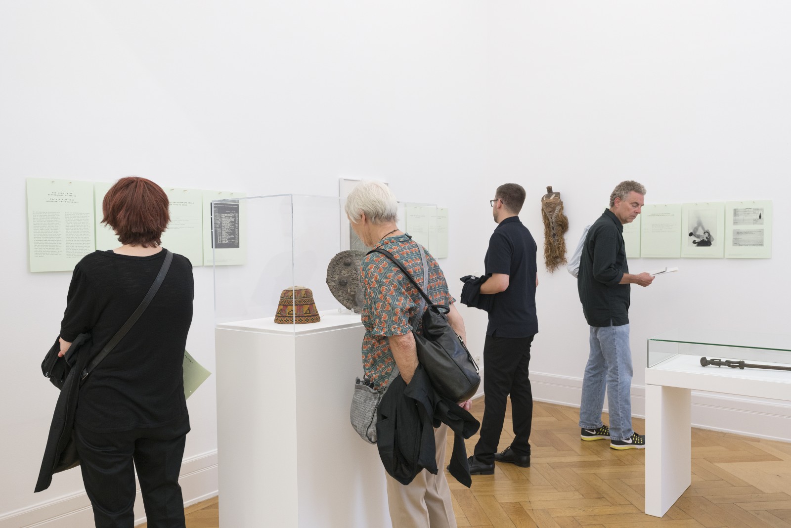 Visitors at the exhibition opening of COLLECTED. BOUGHT. LOOTED?, Weltkulturen Labor 2018