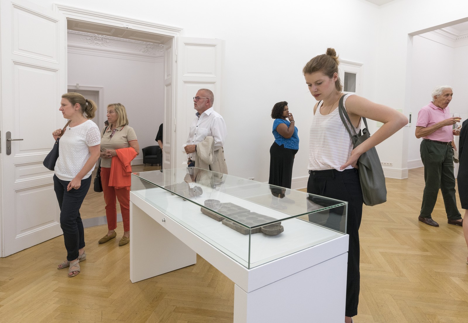 Visitors at the exhibition opening of COLLECTED. BOUGHT. LOOTED?, Weltkulturen Labor 2018