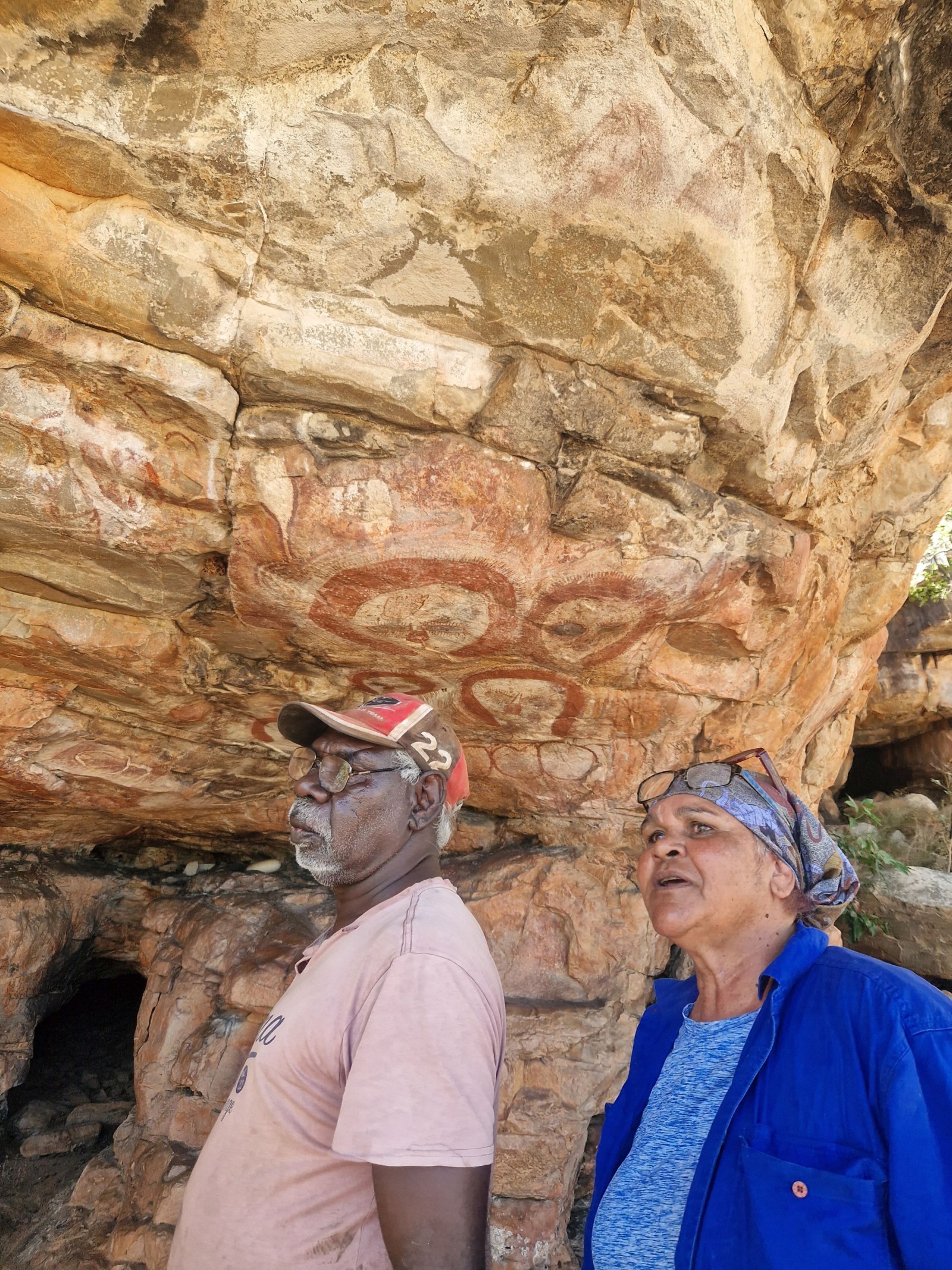 Rona Charles and John Rastus in front of rock art site Maliba II, 2023, approved by Wilinggin Aboriginal Corporation. Photo: Richard Kuba